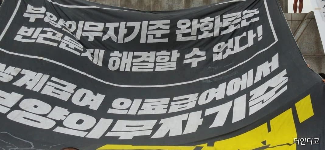 ▲대형현수막에 ‘부양의무자기준 완화로는 빈곤 문제를 해결할 수 없다’는 내용의 글이 적혀 있다. ⓒ더인디고